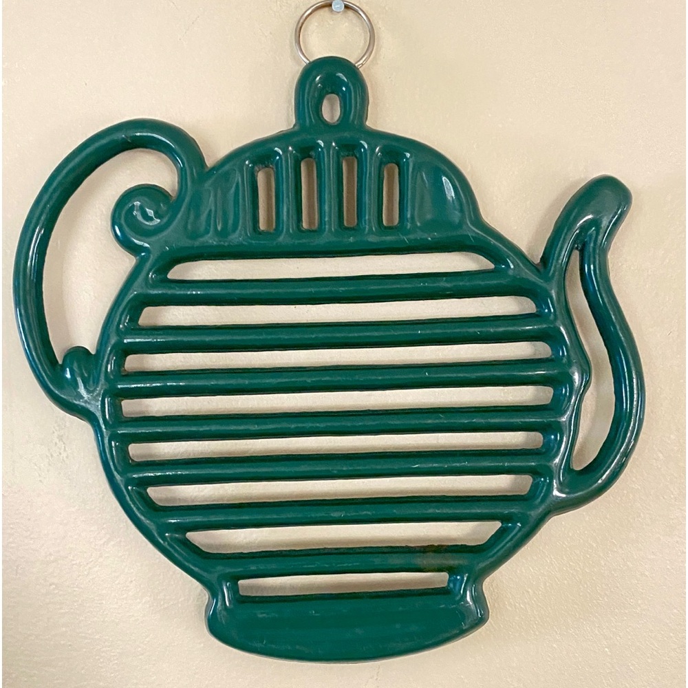 Metal- heavy trivet. Hook for hanging. Tea pot shape. Vintage. Green.